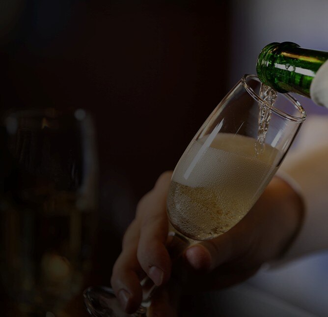 Hand model holding a glass of sparkling wine