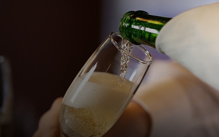 Hand model holding a glass of sparkling wine