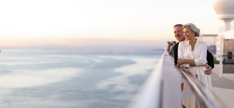 Couple looking out to the sea aboard a luxury cruise ship with Regent Seven Seas Cruises