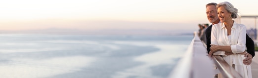 Couple looking out to the sea aboard a luxury cruise ship with Regent Seven Seas Cruises