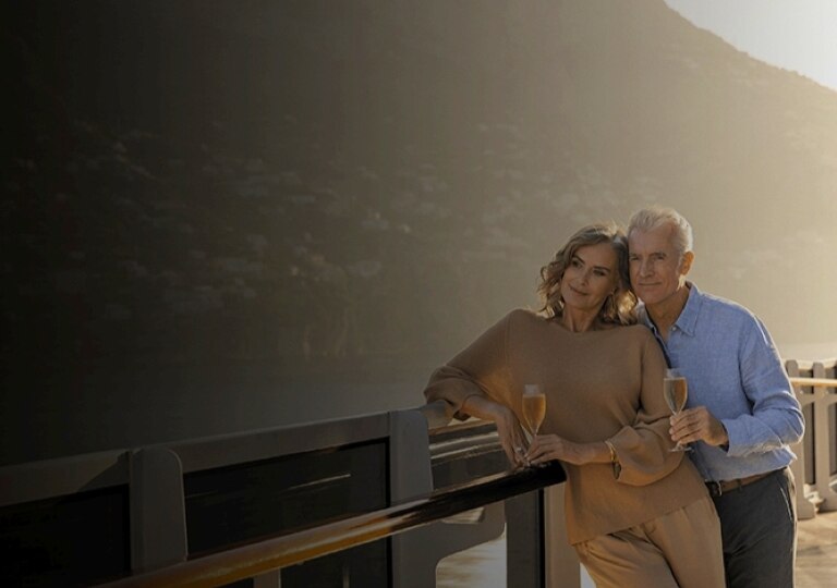 Couple enjoying ocean views from a luxury Regent cruise