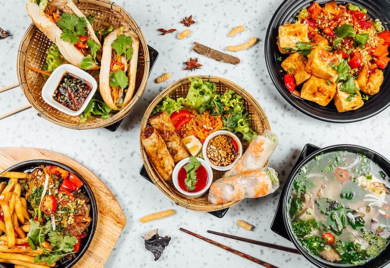 Traditional Vietnamese food including summer rolls, banh mi, tofu and noodle soup