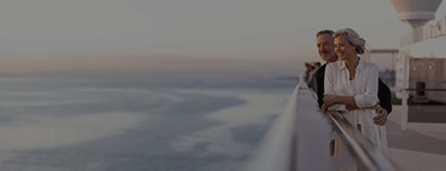 couple looking out at the sea aboard a Regent cruise ship