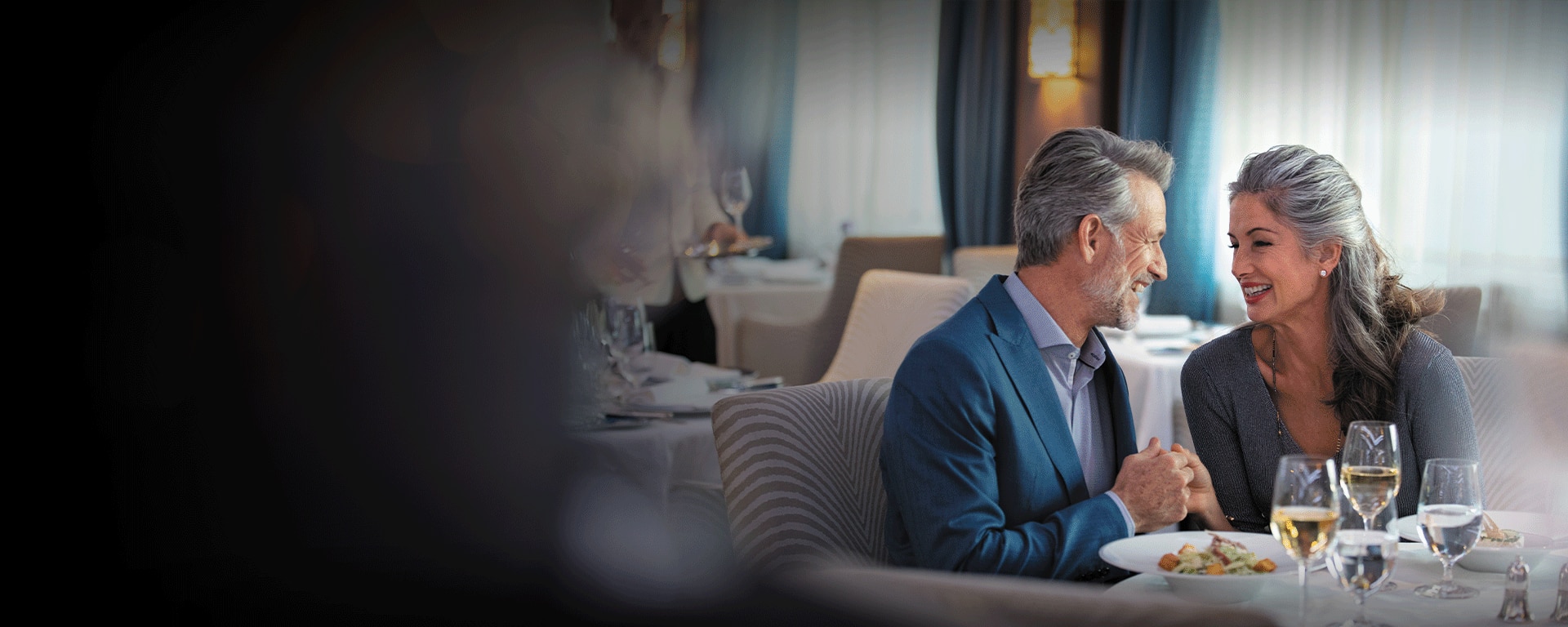 Couple admiring each other while enjoying fine dining aboard a Regent ship